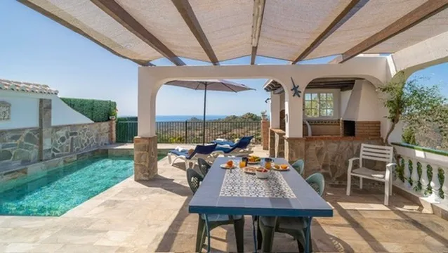 Outdoor dining table next to the pool