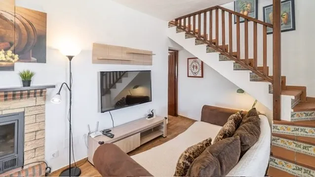 Living room with fireplace, TV and staircase