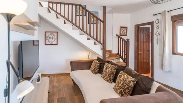 Sofa in the living room beside the stairs