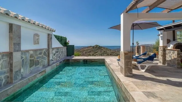 Pool with the mountains and the sea behind