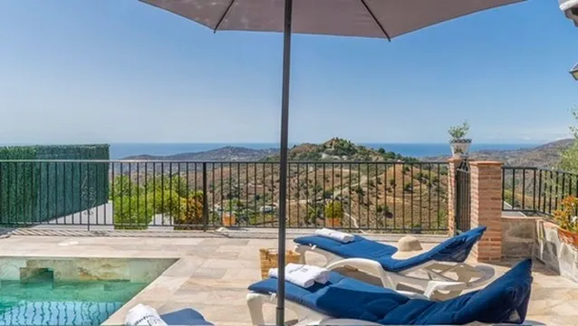 Sun loungers by the pool with Mediterranean views